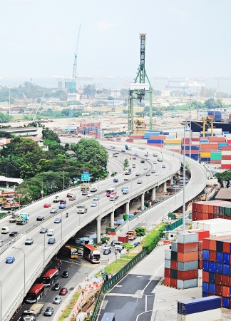 Singapore highway near commercial port . It's the world's busiest port in terms of total shipping tonnage, it transships a fifth of the world shipping containers の写真素材