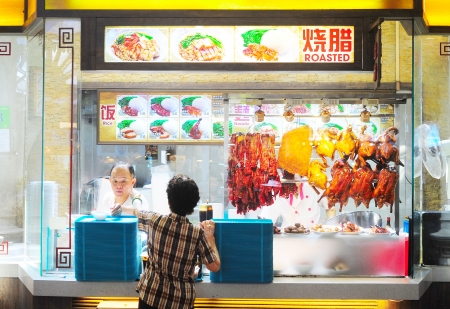 Singapore, Republic of Singapore - March 06, 2013: Food stall  in Singapore. Inexpensive food stalls are numerous in the city so most Singaporeans dine out at least once a day.のeditorial素材