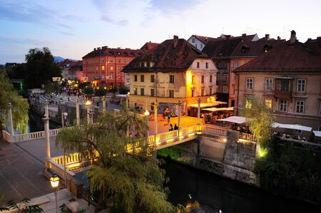 Ljubljana, Slovenia - September 4, 2013: People walking at old town embankment in Ljubljana. This year the city of Ljubljana is competing for the title of European Green Capital 2016.のeditorial素材