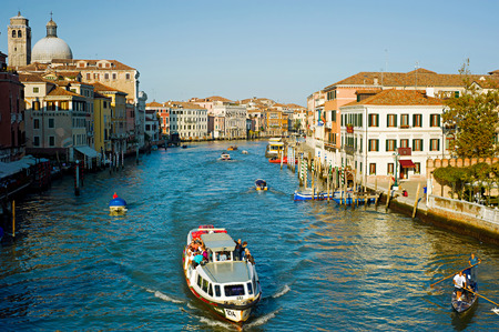 Venice, Italy - September 5, 2013: People touring the famous Venice Canals on boats  in Venice. Currently the city is testing new movable flood barriers.のeditorial素材