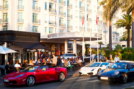 Cannes, France - September 15, 2013: People sitting at a cafe and walking on the street in Cannes. Currently the city is hosting Festival of chefs.のeditorial素材