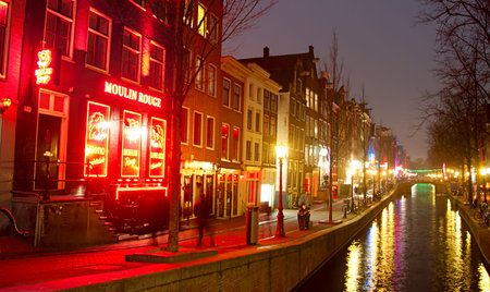 AMSTERDAM, NETHERLANDS - MARCH 10, 2013: Red-light district in Amsterdam. There are about three hundred cabins rented by prostitutes in the area.のeditorial素材