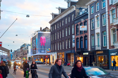 AMSTERDAM, NETHERLANDS - MARCH 04, 2014: Unidentified people riding bicycles on the street of Amsterdam. It is one of the most cycle-friendly cities in the world. 58% of the citizens uses daily a bicycle.のeditorial素材