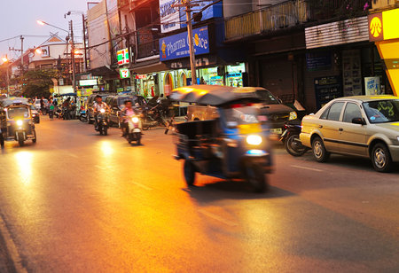 CHIANG MAI, THAILAND - FEB 26, 2013: Busy traffic on a road at dusk in Chiang Mai. Chiang Mai is the...