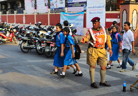 CHIANG MAI, THAILAND - FEB 27, 2013: Young policeman at work in Chiang Mai. Chiang Mai is the largest and most culturally significant city in northern Thailand.のeditorial素材