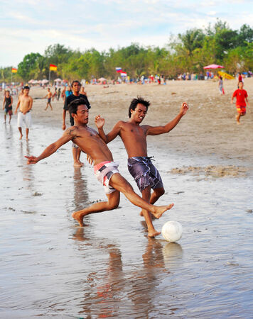 KUTA, BALI ISLAND, INDONESIA - APRIL 4, 2012: People plaing soccer on the beach in Kuta, Indonesia. Football is the most popular sport in Indonesia. The Indonesian football league started around 1930 
のeditorial素材