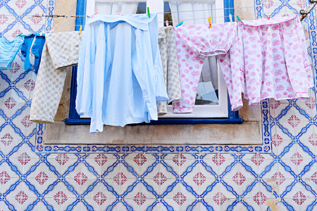 Drying clothes hanging on a clothesline in Lisbon, Portugalの写真素材