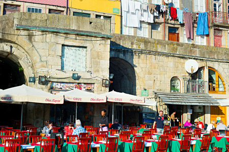 PORTO, PORTUGAL - JAN 12, 2015: Unidentified people at street restaurant on the embankment of Porto. Porto is one of the oldest European centres, and its historical core was proclaimed a World Heritage Site by UNESCO in 1996のeditorial素材