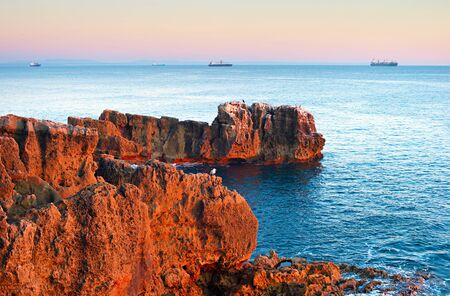 The rocky coastline of Cascais - famous tourist destination. Portugalの写真素材