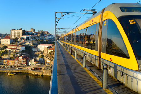 PORTO, PORTUGAL - JAN 12, 2015: Modern light rail tram over the Dom Luis bridge in Porto city, Portugal.のeditorial素材