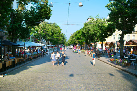 ODESSA, UKRAINE - MAY 26, 2015: People walking on Deribasovskaya street at sunset. Deribasovskaya street is a famous tourist attractionのeditorial素材