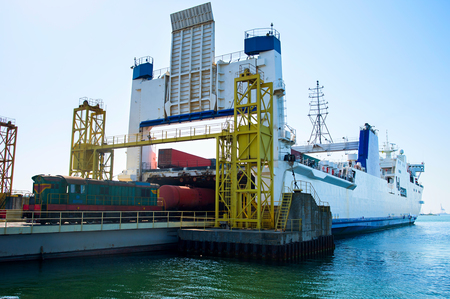 Unloading the industrial cargo ship with train locomotive. Ilyichevsk, Ukraineの写真素材