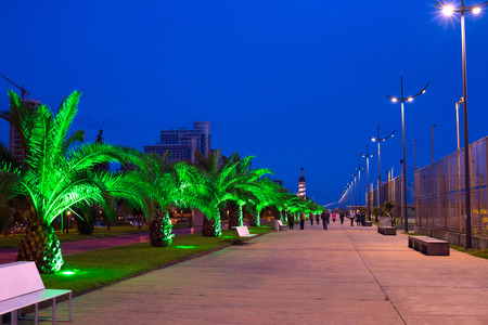 BATUMI, GEORGIA - MAY 13, 2015: People walking on embankment at twilight in Batumi. Batumi - city on the Black Sea coast and capital of autonomous republic Adjara, Georgia.のeditorial素材