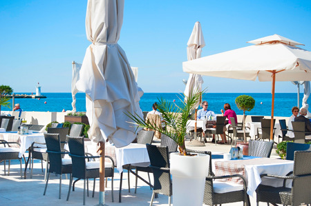 Novigrad, Croatia - October 01, 2013: People at outdoor restaurant in front of the sea. Around 14 million tourists visit Croatia within a year.のeditorial素材