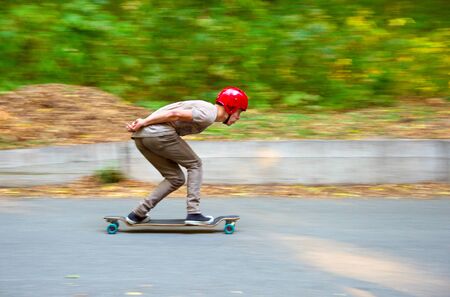 KIEV, UKRAINE - OCTOBER 03, 2015: Man on a longboard moving fast during DH - Race contest in Kiev, Ukraineのeditorial素材