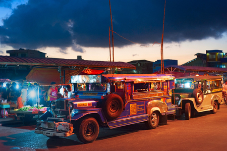LEGAZPI, PHILIPPINES - APRIL 07, 2012:  Jeepneys waiting for passengers on the street. Jeepneys are public transport. They were originally made from US military jeeps left over from World War II.のeditorial素材