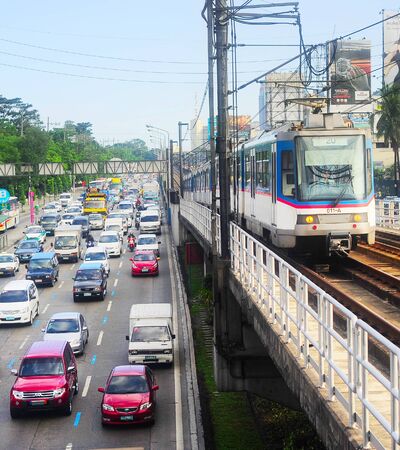 MANILA, PHILIPPINES - APRIL 03, 2012: LRT train on a railroad in Manila, Philippines. LRT serves 579,000 passengers each day. Its 31 stations along over 31 kilometersのeditorial素材