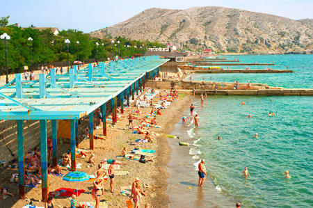 SUDAK, UKRAINE - SEPT 08, 2015: People at a sea beach in Sudak. According to National Geographic, Crimea was among the top 20 travel destinations in 2013のeditorial素材