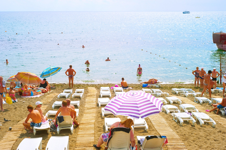 SUDAK, UKRAINE - SEPT 08, 2015: People at a sea beach in Sudak. According to National Geographic, Crimea was among the top 20 travel destinations in 2013のeditorial素材