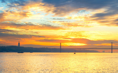 Tagus river, Christ the King statue and 25 April bridge at sunset. Lisbon, Portugalの写真素材