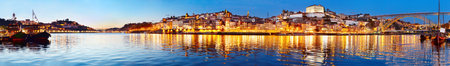 Panoramic view of Porto at twilight with reflection in Douro river. Portugal