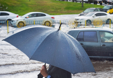 Man under umbrella in the rainの写真素材