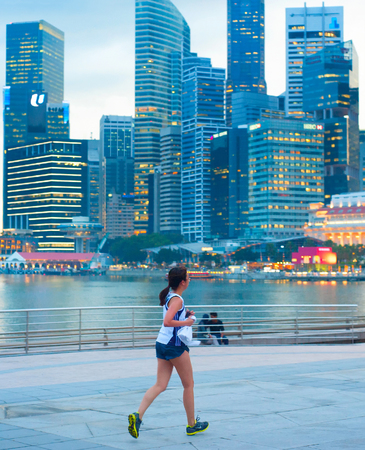 SINGAPORE - MAY 06, 2012: Unidentified people runnig in front of Singapore downtown in Singapore. Singapore has been recognized as one of the best cities for runners in Asia.のeditorial素材