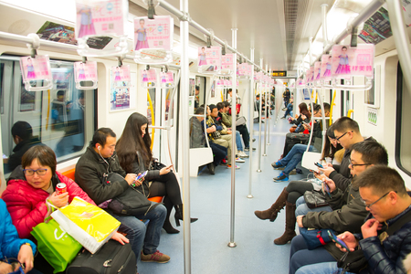 SHANGHAI, CHINA - DEC 26, 2016: People inside a subway train. With an operating route length of 439 km, Shanghai has the third longest metro in the world.のeditorial素材