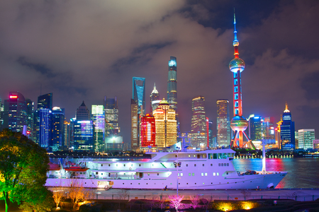 Night view of Shanghai with passenger ship on foregroundの写真素材