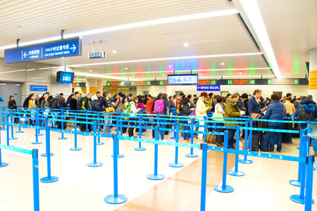 SHANGHAI, CHINA - DEC 26, 2106: People at Shanghai Pudong Airport arrival immigration counter....