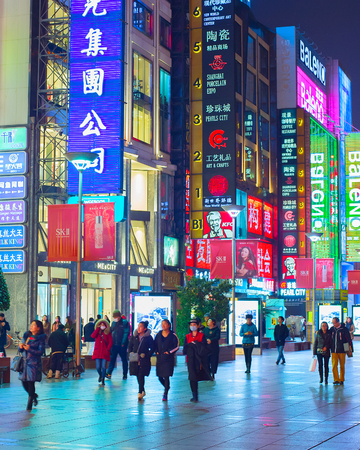 SHANGHAI, CHINA - DEC 28, 2016: People walking on Nanjiing road in Downtown of Shanghai. The area is the main shopping district of the city and one of the world's busiest shopping streets.のeditorial素材