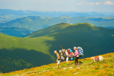 CARPATHIANS MOUNTAINS, UKRAINE - AUG 04, 2016: Group of hikers with a dog on top of mountains. Ukraine used to attract more than 20 million tourist every year.のeditorial素材