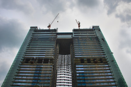 Construction of a modern skyscraper with dark frighten sky