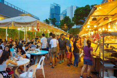 SINGAPORE - JAN 14, 2017 : People at popular food court in Singapore. Inexpensive food courts are numerous in the city so most Singaporeans dine out at least once a day.のeditorial素材