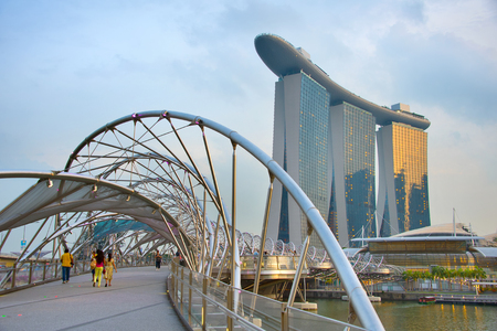 SINGAPORE - JAN 13, 2017: Helix bridge and Marina Bay Sands Resort at twilight in Singapore. Marina Bay as the world's most expensive standalone casino property at S$8 billionのeditorial素材