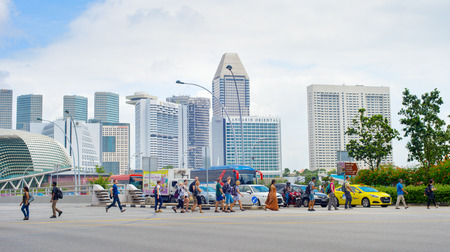 SINGAPORE - JAN 14, 2017: People crossing the road in Singapore. Singapore is a global commerce, finance and transport hubのeditorial素材