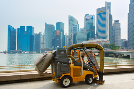 SINGAPORE - JAN 14, 2017: Cleaning vehicle in front of Singapore Downtown. Singapore is a global commerce, finance and transport hub.のeditorial素材