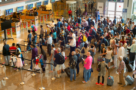 SINGAPORE - JAN 13, 2017: People waiting in queue at arrival immigration of Changi airport. Changi International Airport serves more than 100 airlines operating 6,100 weekly flights.のeditorial素材