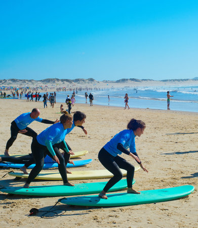 BALEAL, PORTUGAL - JUL 30, 2017: Coach show how to surf to the group of surfers. Ericeira is the...