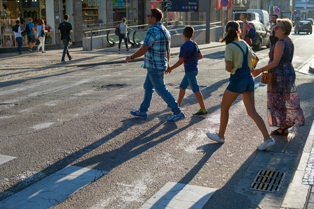 PORTO, PORTUGAL - JULY 13, 2017: People crossing the road at Santa Catarina street. Santa Catarina is the main shopping street in Porto.のeditorial素材