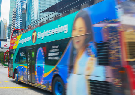 SINGAPORE - FEB 16, 2017: Tourist sightseeing hop on hop off bus in Downtown of Singapore.のeditorial素材