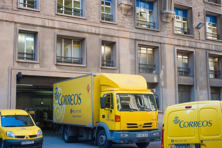 Yellow Correos post trucks in the street of Baecelona, Spainのeditorial素材