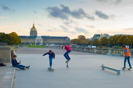 Boy taking picture of skating teen kids , parliament buiding at the background, Paris Franceのeditorial素材