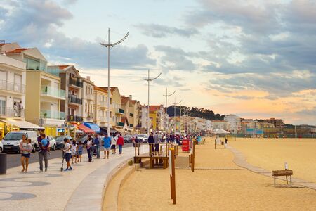 NAZARE, PORTUGAL - OCTOBER 14, 2018: People walking at promenade of Nazare. Nazare is a famous sea summer holiday destination in Portugalのeditorial素材