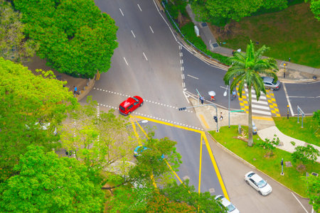Aerial view of road traffic in Singapore. People crossing the road