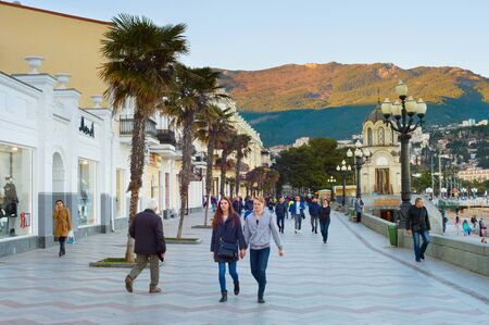 YALTA, CRIMEA, UKRAINE - APRIL 03, 2018: Couple walking by Yalta promenade at sunset. Yalta is the most famous tourist destination in Crimeaのeditorial素材