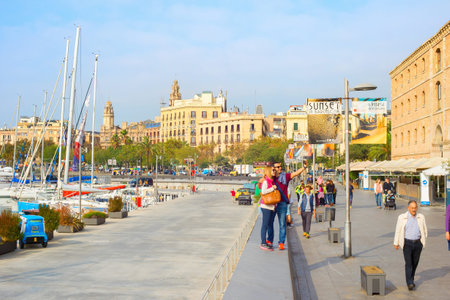 BARCELONA, SPAIN - NOVEMBER 3, 2016: Couple taking selfie with smartfon on Barcelona embankment by...