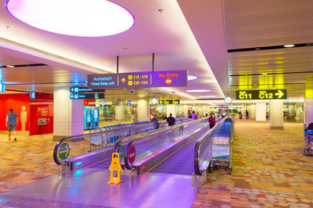 SINGAPORE - JANUARY 16, 2017: People at travelator in Changi International arrival airport hall