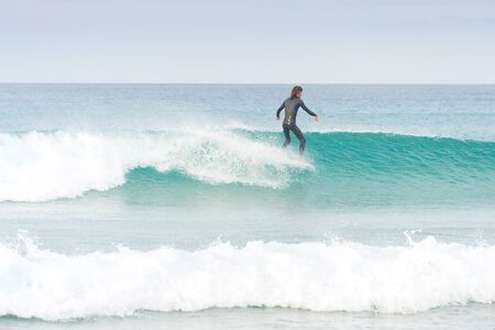 PENICHE, PORTUGAL - DECEMBER 02, 2016: Surfer riding a wave on surfboard. Peniche is a famous surfing destination in Portugalのeditorial素材