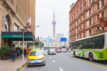 SHANGHAI, CHINA -DECEMBER 28, 2016: Traffic on the road in Downtown of Shanghai with view to TV Tower.のeditorial素材